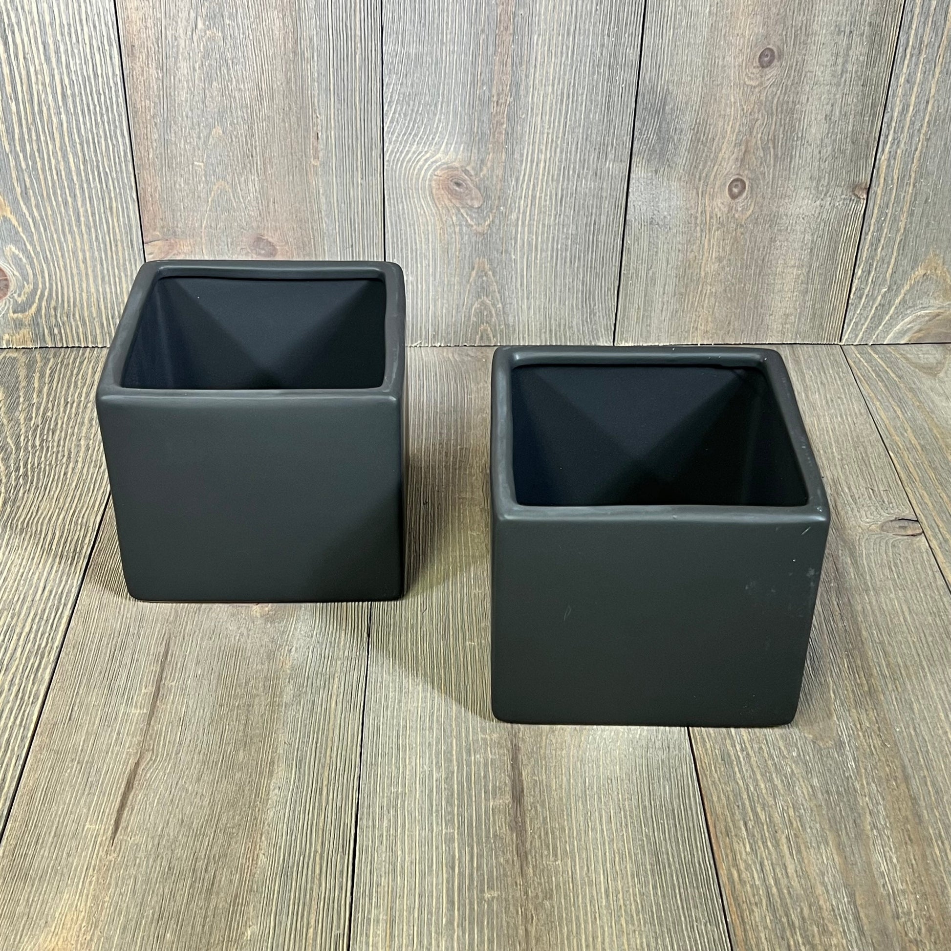 Set of 2 modern black ceramic square planters, perfect for succulents and small plants, enhancing any decor.