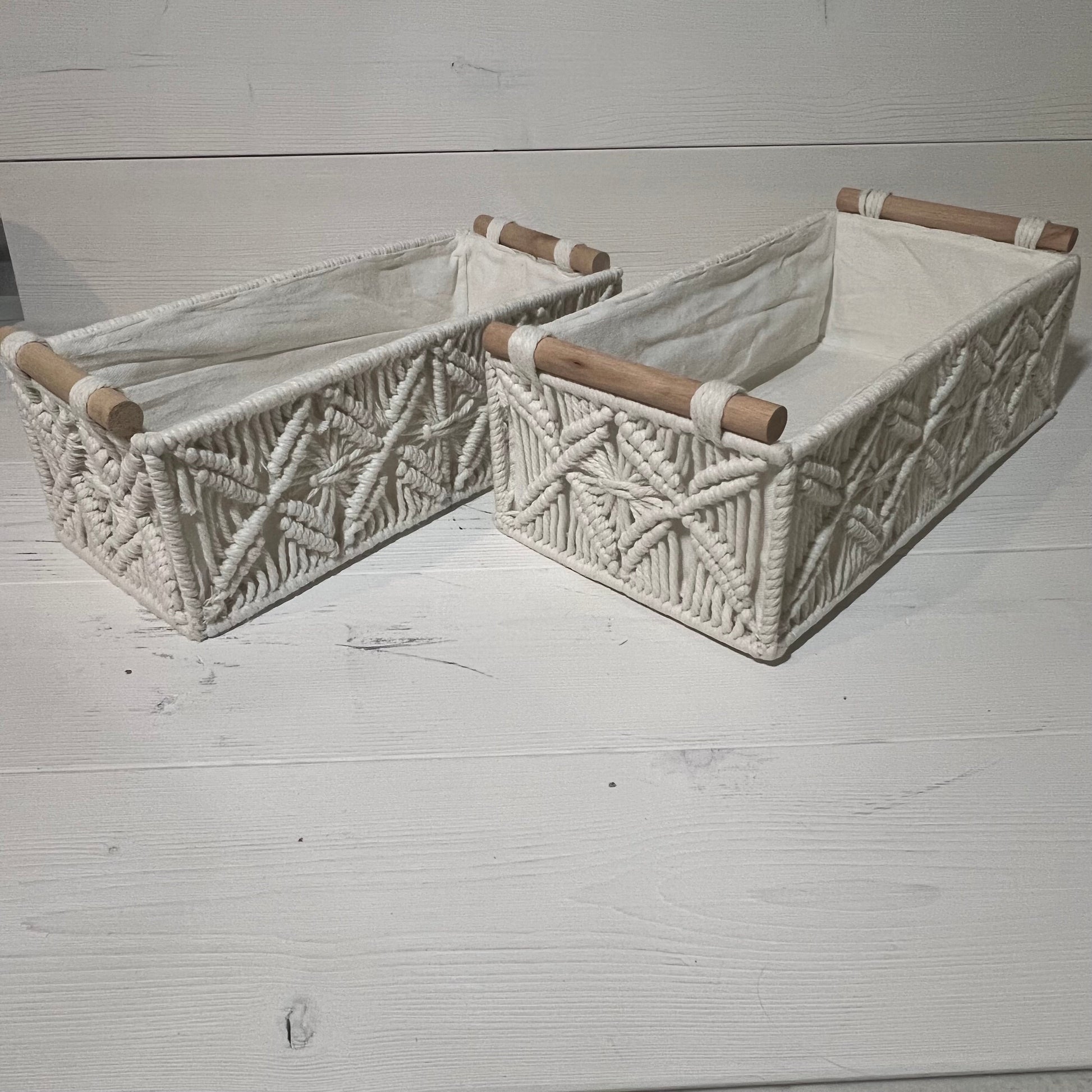 Handwoven macrame storage baskets in ivory white, featuring wooden handles, perfect for bathroom or bedroom organization.