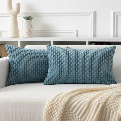 Soft corduroy throw pillow covers in blue-grey, adding a boho touch to a white sofa for cozy home decor.