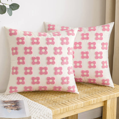 Pink and white daisy sunflower jacquard pillow covers on a woven bench, perfect for living room or bedroom decor.