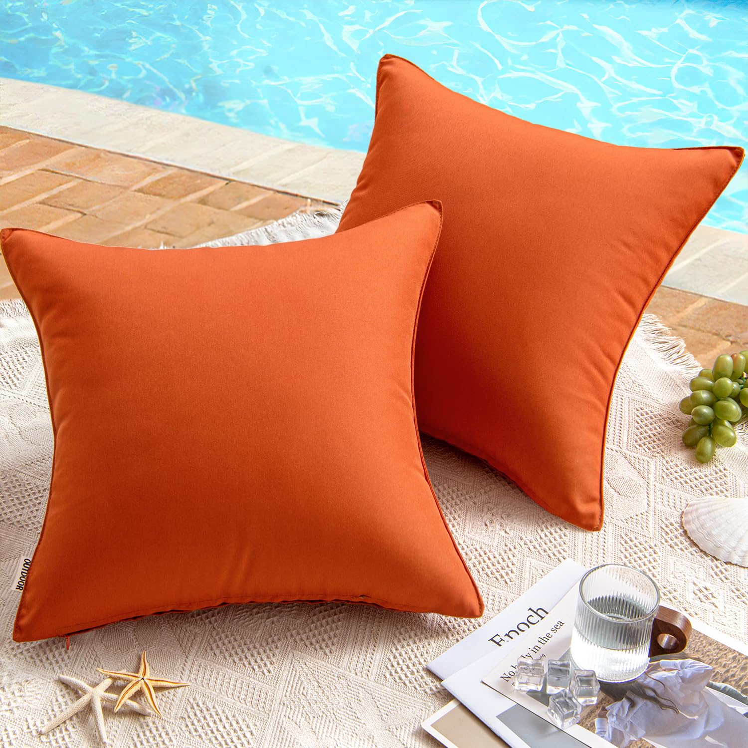 Burnt brick waterproof pillow covers by the pool on a lace cloth, ideal for outdoor patio decor.