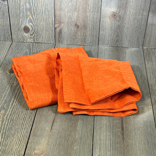 Orange waterproof pillow covers on rustic wood, perfect for outdoor decor on patios, balconies, or sofas, 16x16 inch.