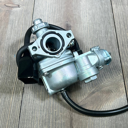 Honda TRX90 carburetor replacement on wooden surface, suitable for models 1993-2006.
