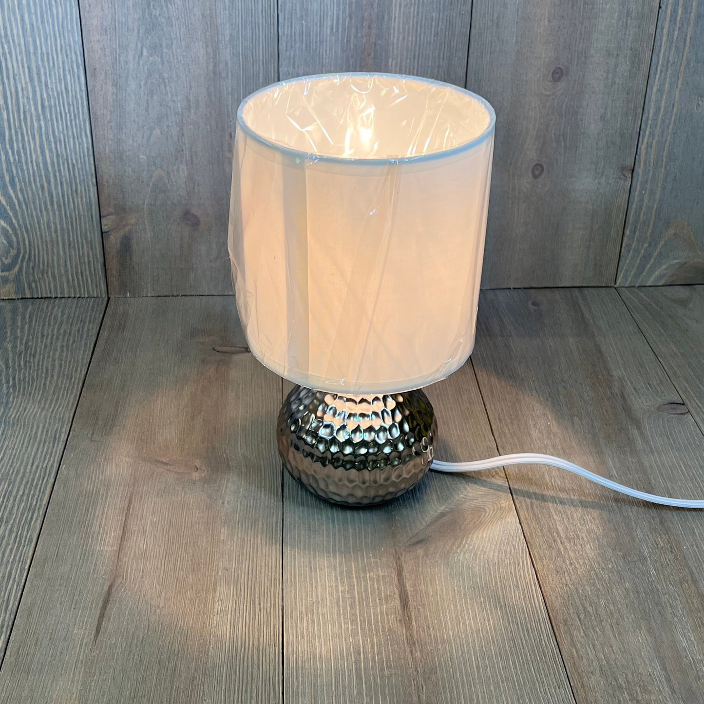 Mini hammered texture silver table lamp with white shade, perfect for modern decor.