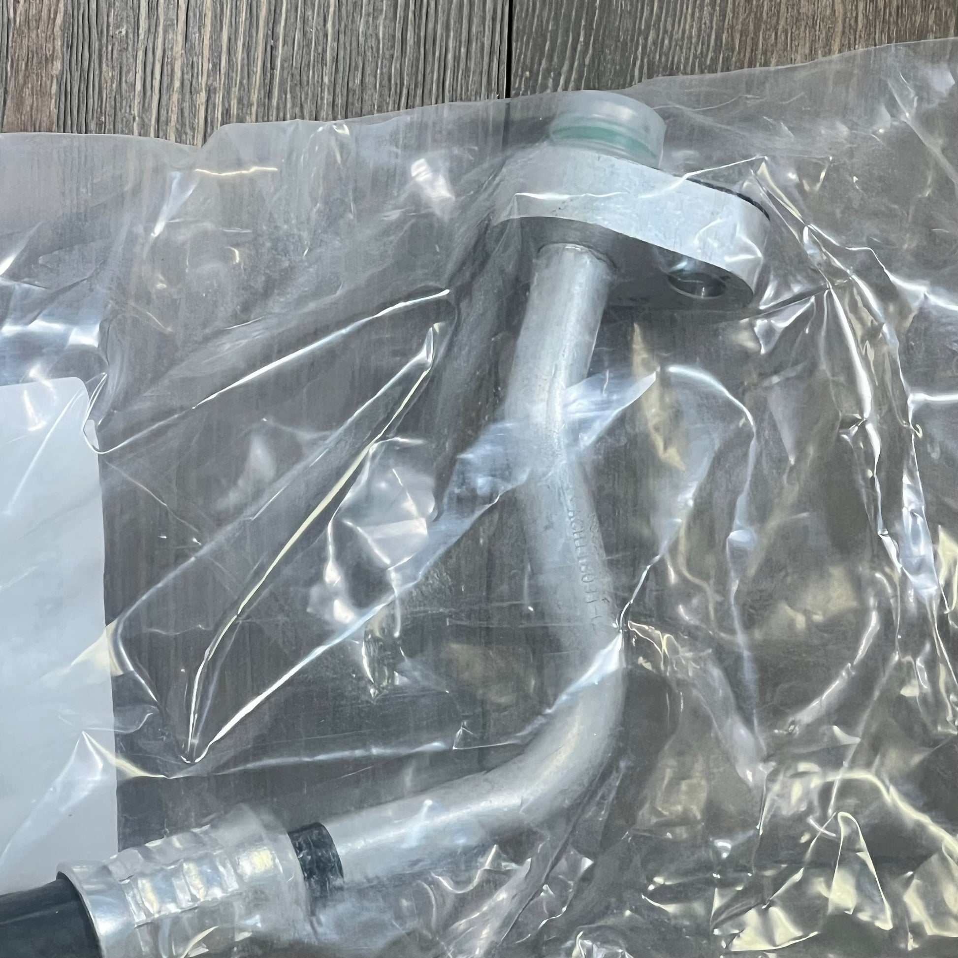 Premium A/C discharge line hose assembly for Jeep Wrangler 2007-2011, showing durable metal construction in packaging.