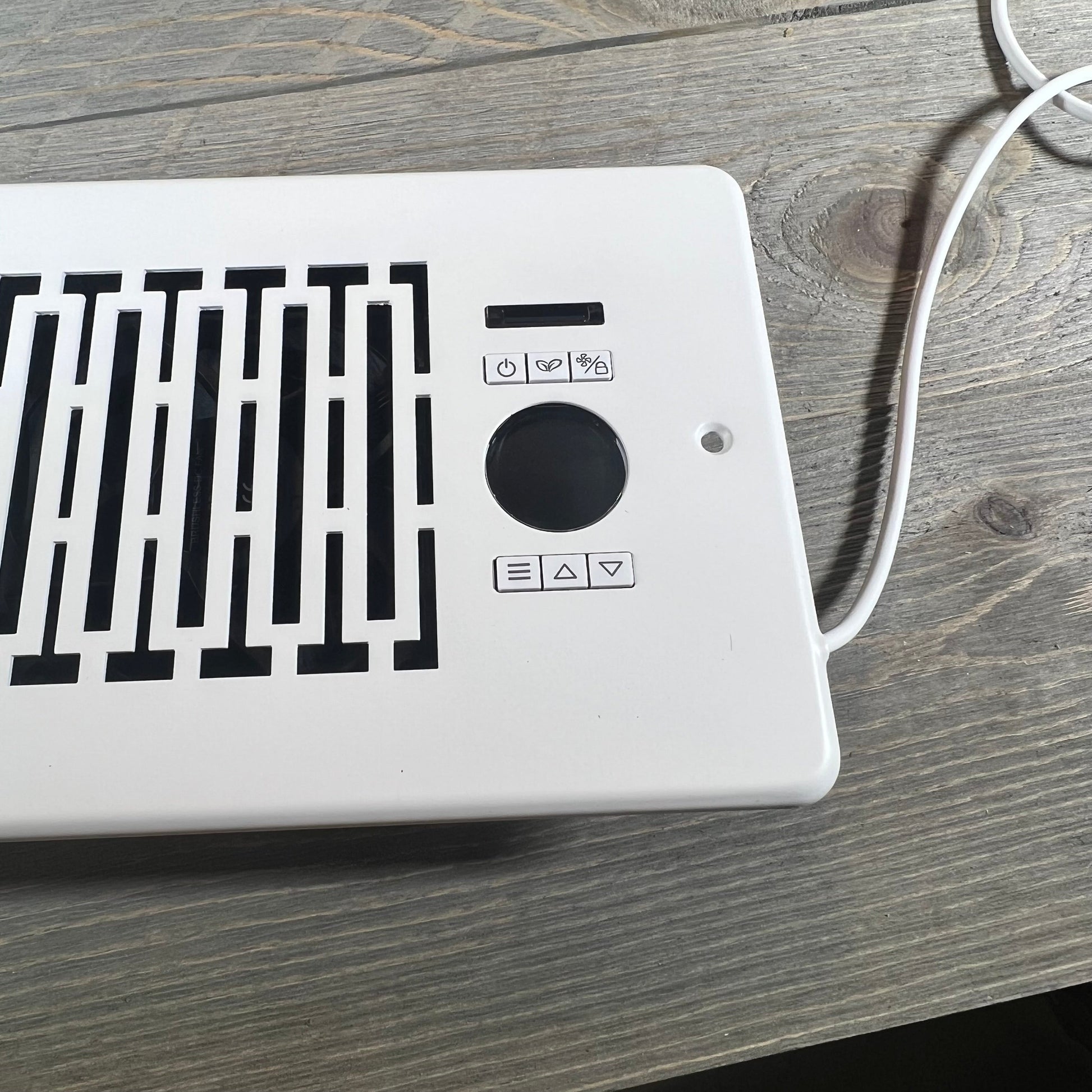 Sleek design of a smart booster fan for 4" x 10" vents with intuitive remote control interface.