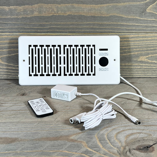 Smart Register Booster Fan with remote, cable, and adapter displayed on a wooden surface for 4" x 10" vents.