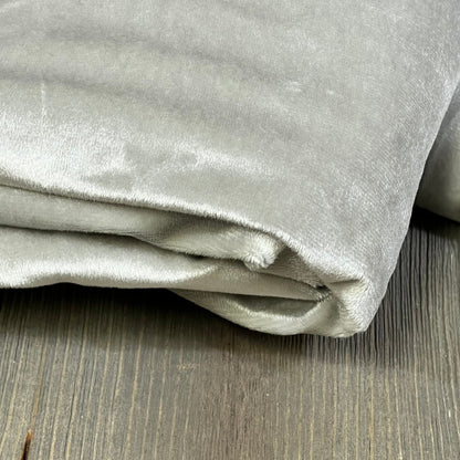 Folded MIULEE grey blackout curtain on wooden floor, showcasing soft fabric and thermal insulation for living room or bedroom.