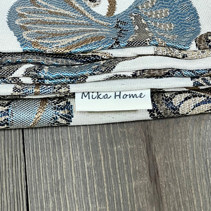 Blue cream jacquard tropical leaf pillow covers by Mika Home, showing detailed texture and elegant design.