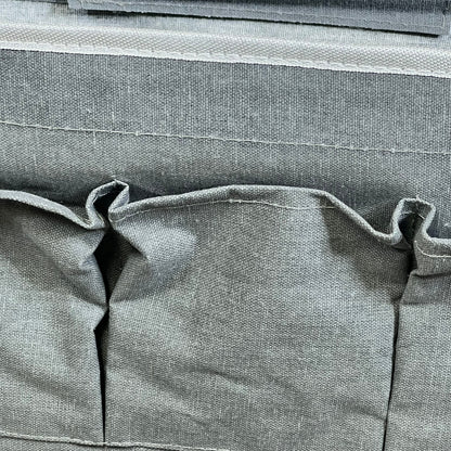 Gray linen wall organizer with three large pockets, ideal for kitchen or bedroom storage.