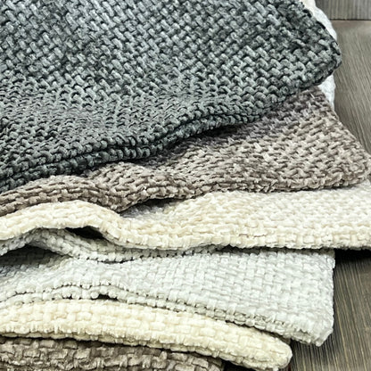 Neutral chenille pillow covers stacked, showcasing soft texture and boho farmhouse style for modern home decor.