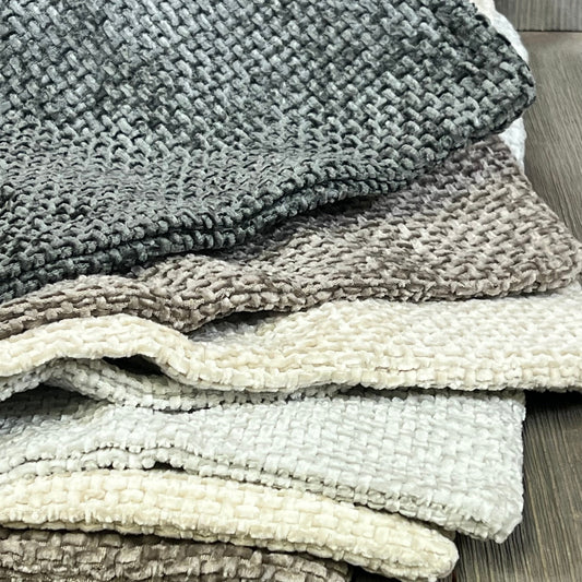 Neutral chenille pillow covers stacked, showcasing soft texture and boho farmhouse style for modern home decor.