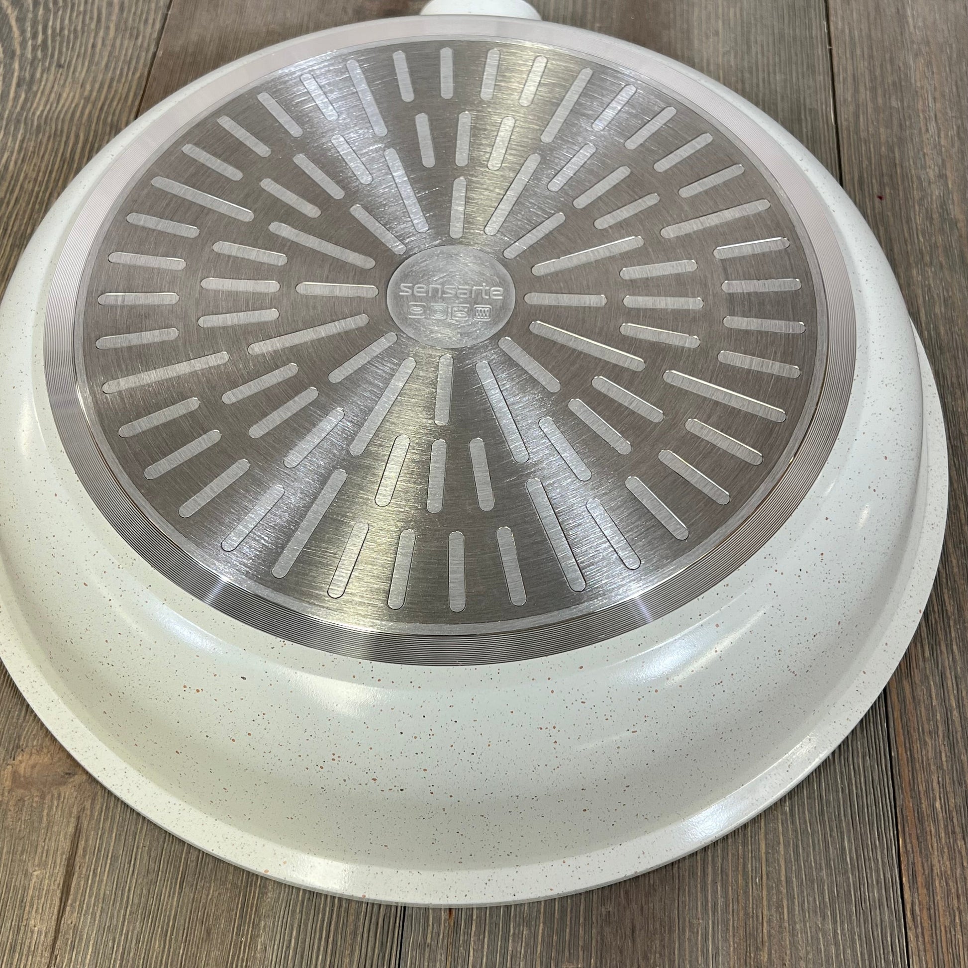 White Sensarte nonstick ceramic frying pan base, featuring induction-compatible design and PFAS-free material.