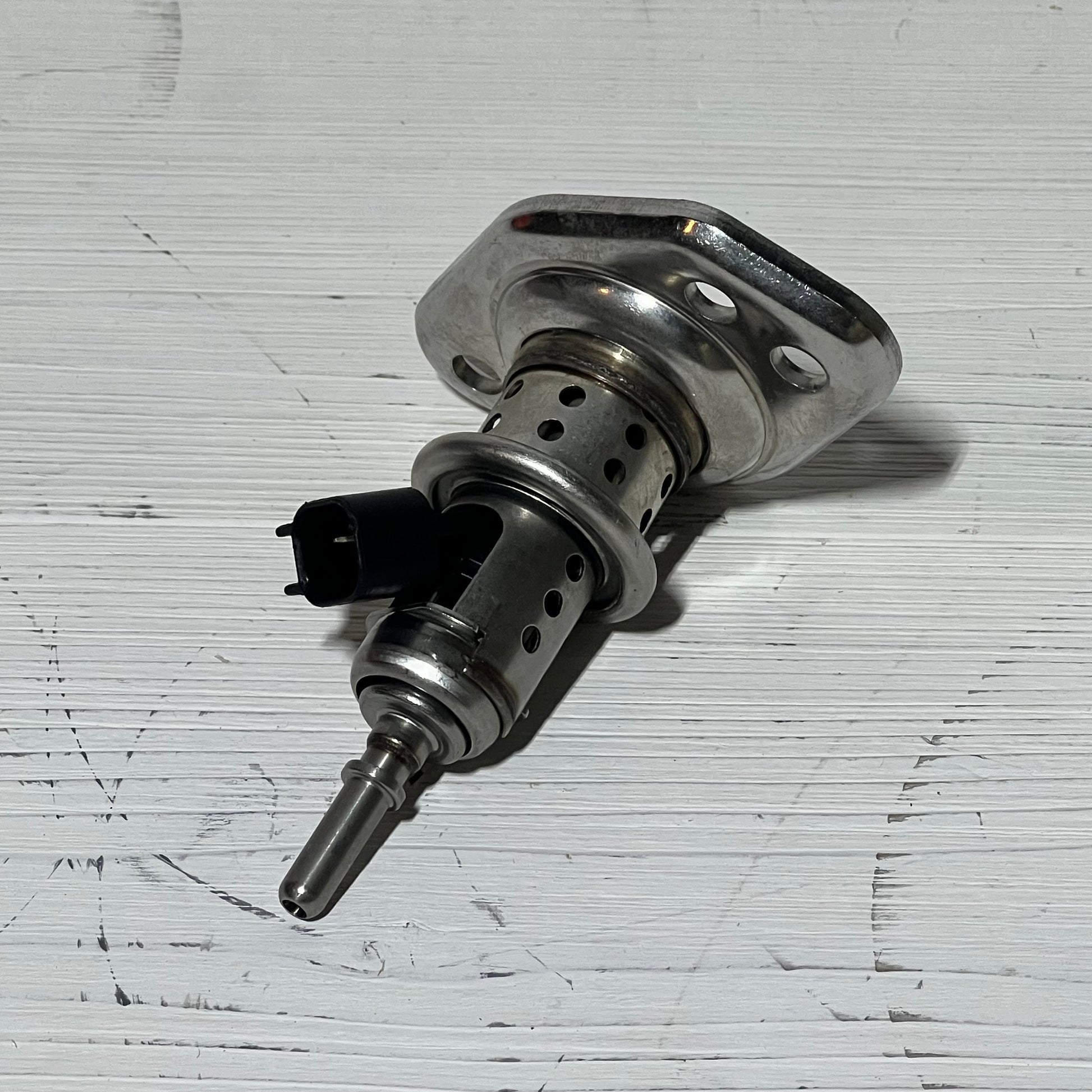 Diesel Exhaust Fluid Injector compatible with Ram and Ford Super Duty trucks, showcasing durable metal design.
