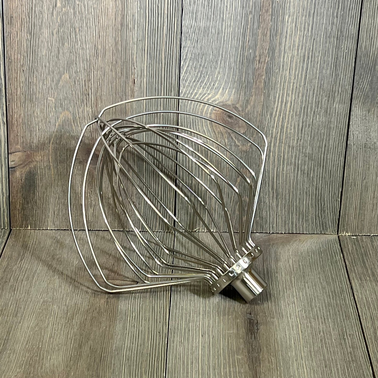 Stainless steel 11-wire whip attachment for KitchenAid 7 quart mixer, perfect for whipping eggs and cream, dishwasher safe.