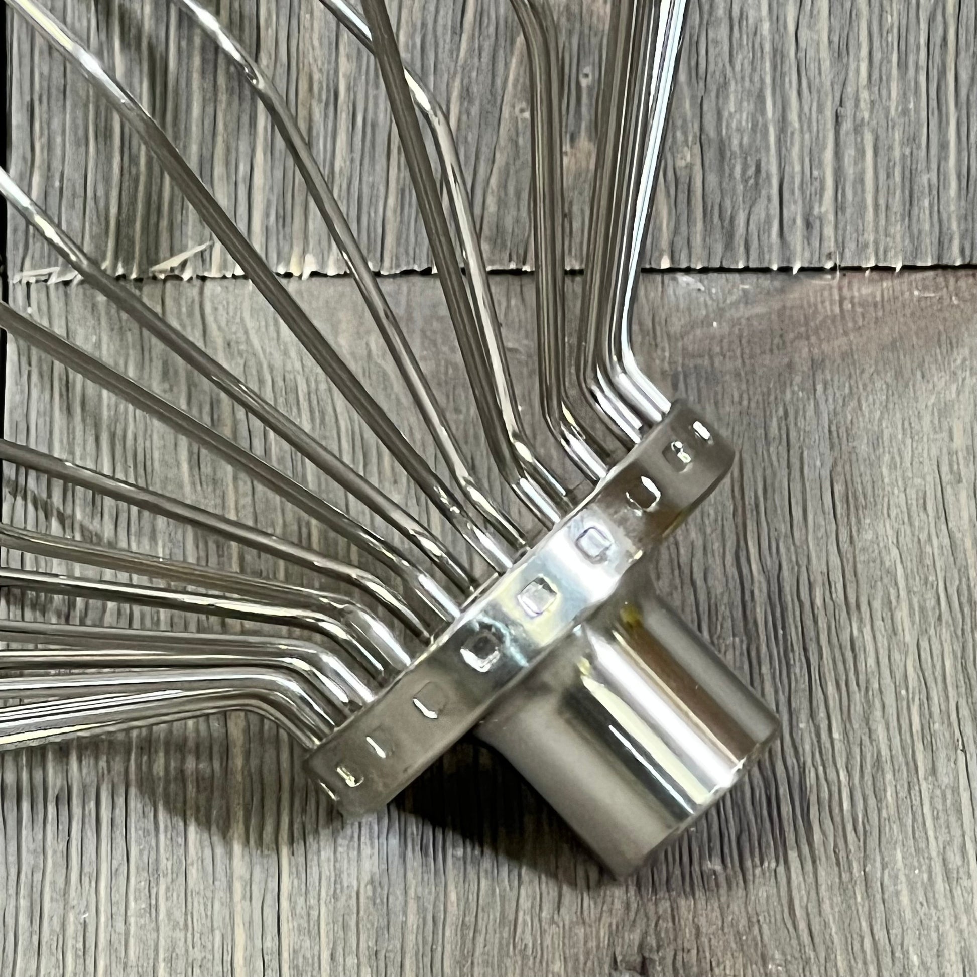 Stainless steel 11-wire whip attachment for KitchenAid 7-quart mixer, perfect for beating eggs and heavy cream.