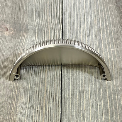 Brushed satin nickel cabinet handle with ribbed design, perfect for kitchen drawers and cupboards. 3-inch size.