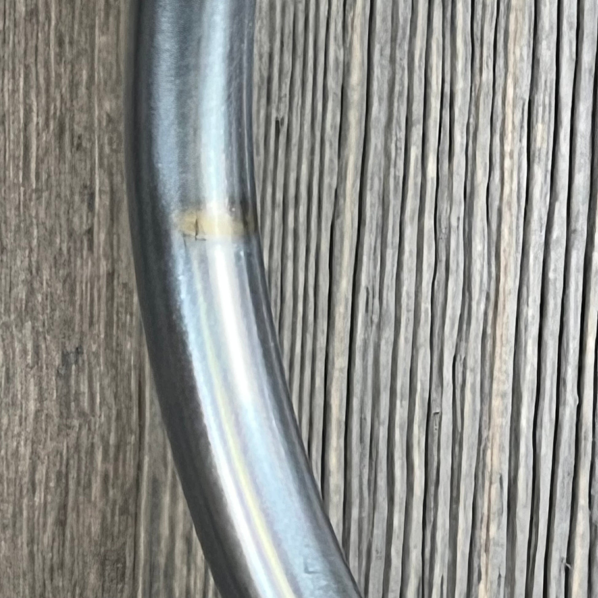 Close-up of the Allied Brass Carolina Collection towel stand's satin chrome finish on a wooden background.