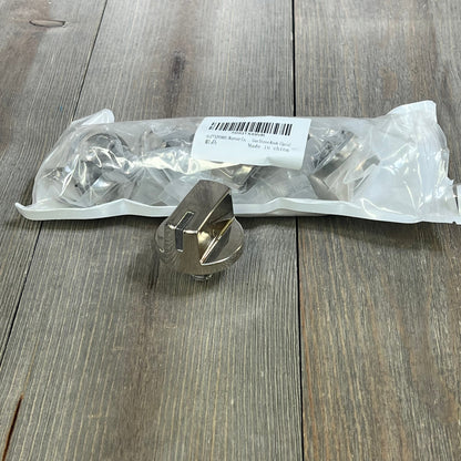 Stainless steel burner control dial for LG range stove, shown with packaging on a wooden surface.