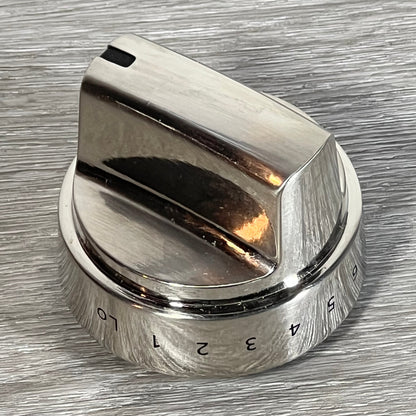 Stainless steel GE stove knob replacement on a textured surface, showing clear number markings for easy adjustment.