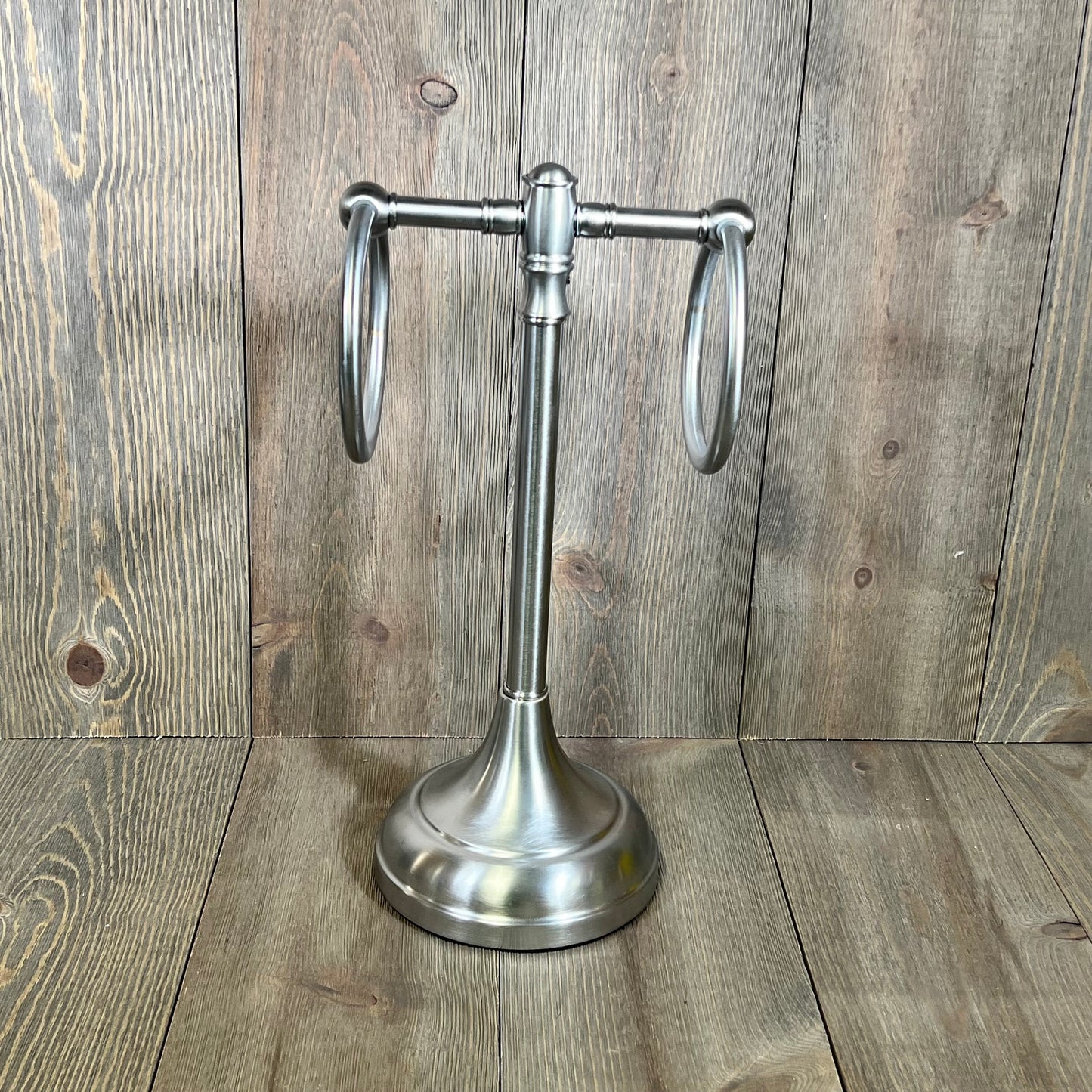 Satin chrome guest towel stand with dual rings from Allied Brass Carolina Collection, elegantly set against a wooden backdrop.