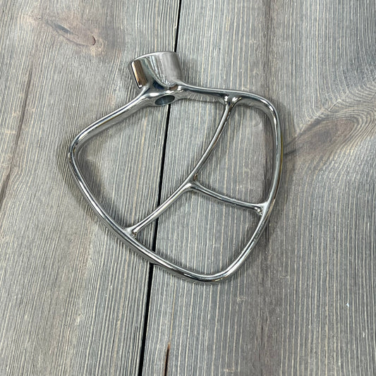 Stainless steel flat beater for KitchenAid mixers, fits 4.5-5 QT bowls, on wooden surface. Ideal for mixing and baking tasks.