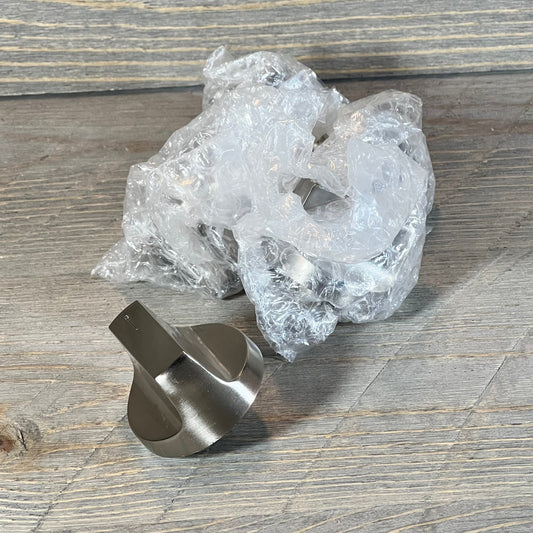 Stainless steel stove knob for Whirlpool gas range, shown with protective bubble wrap packaging.
