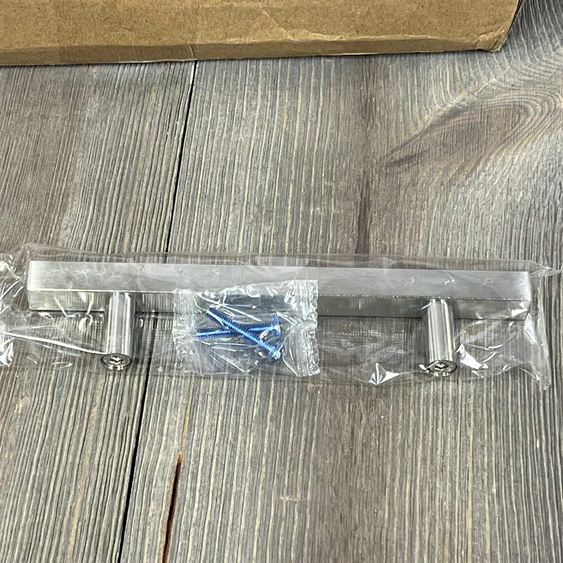 Brushed nickel cabinet handle with screws, 4-inch satin nickel square pull for kitchen, shown on wood background.