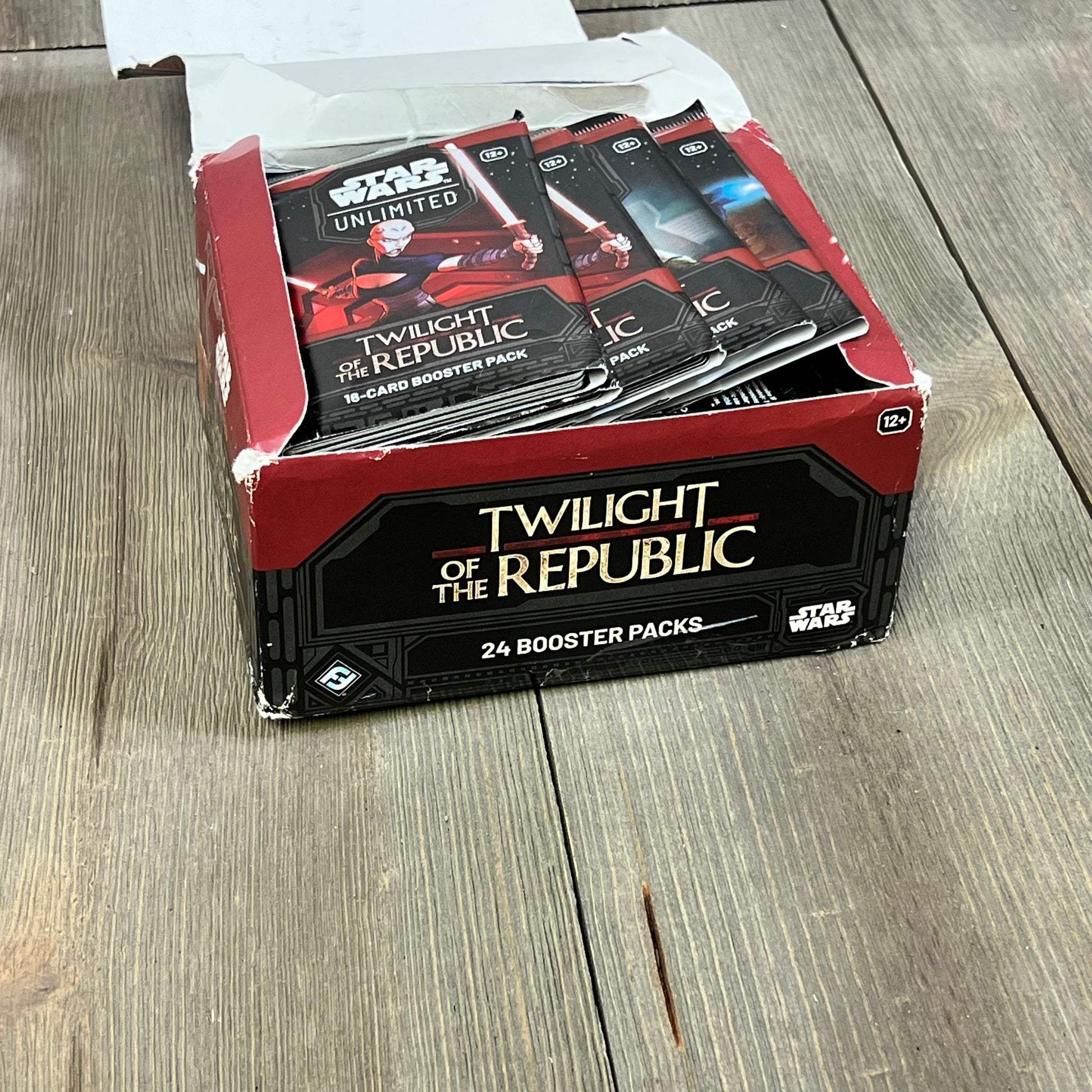Star Wars Unlimited TCG Twilight of The Republic Booster Display with 24 packs on a wooden table.
