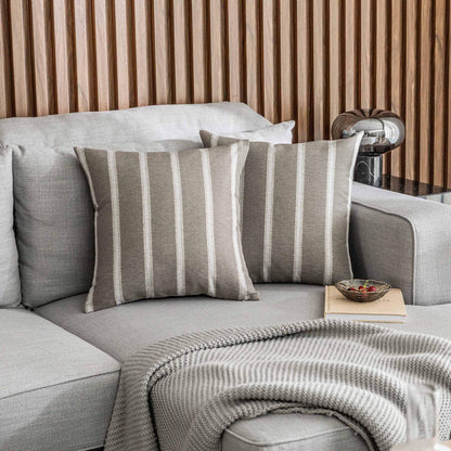 Tan stripe decorative pillow covers on a modern grey sofa, 24x24 inches, perfect for living room decor. Set of 2 Euro shams.