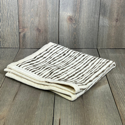 Dark brown chenille striped pillow cover folded on wooden surface, ideal for couch, chair, or bed decor, 18x18 inches.