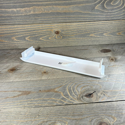 Sturdy Frigidaire refrigerator door shelf bin on wooden surface, ideal for maximizing fridge storage space.
