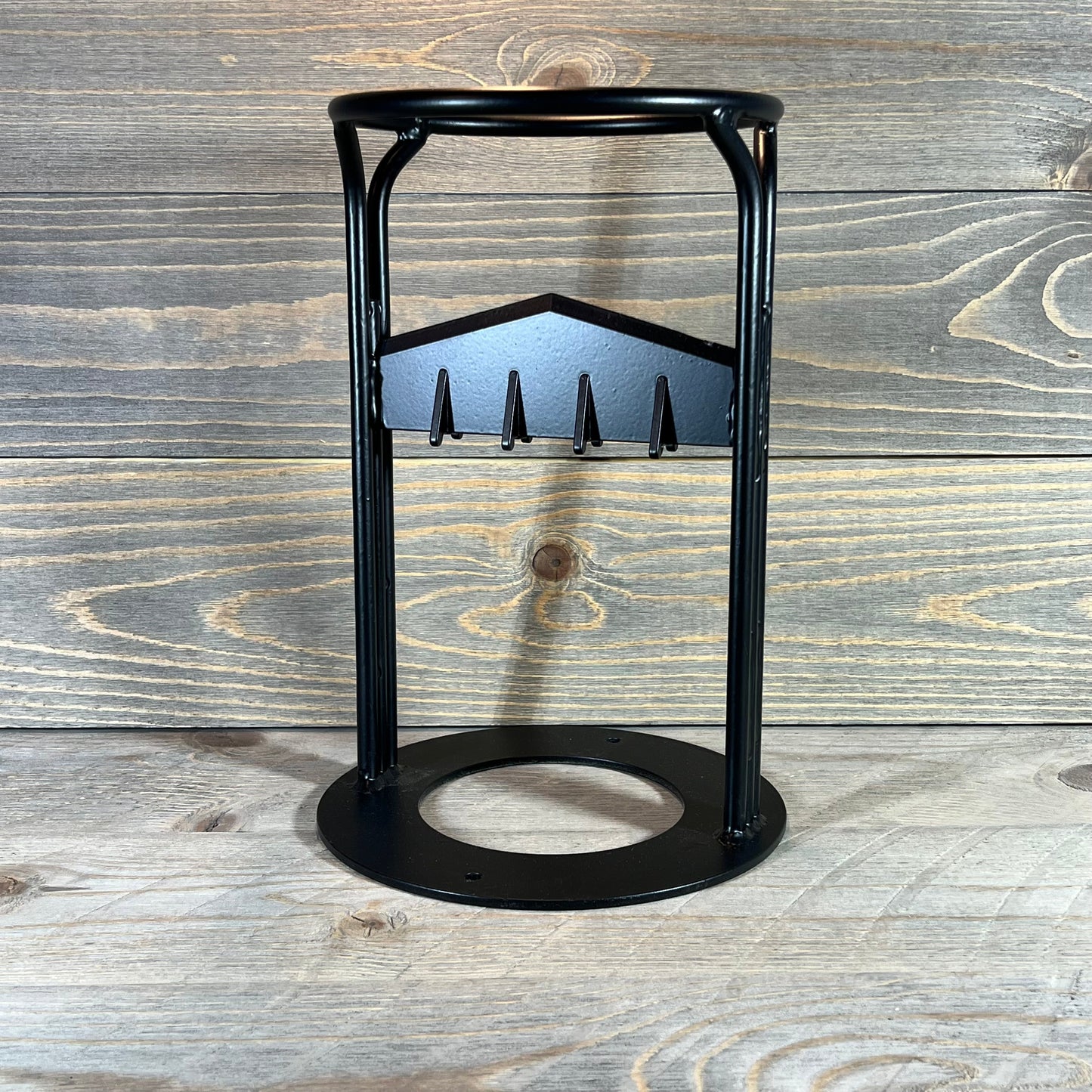 Sturdy manual wood splitter wedge with a black metal frame, ideal for efficient log splitting on a wooden background.