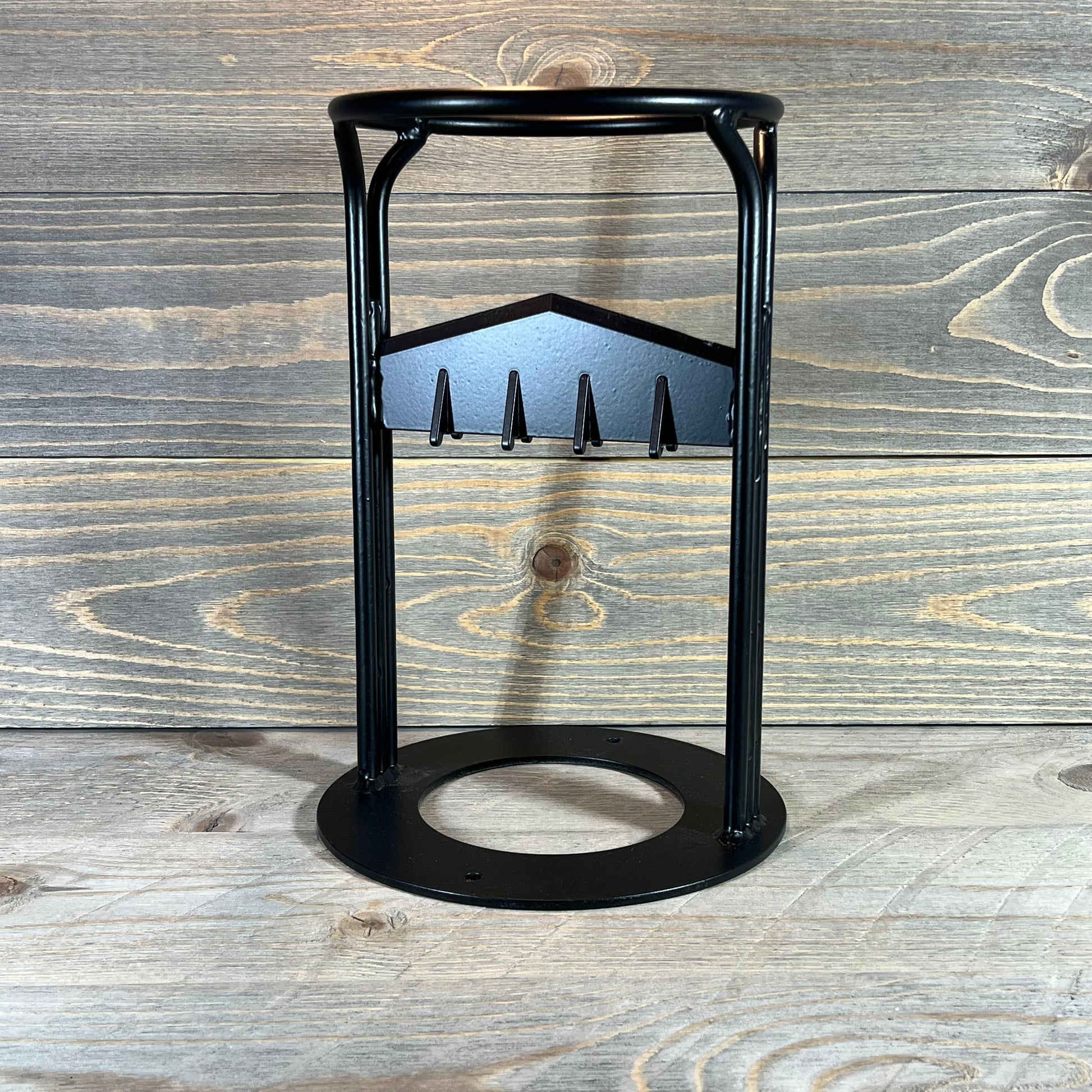 Sturdy manual wood splitter wedge with a black metal frame, ideal for efficient log splitting on a wooden background.