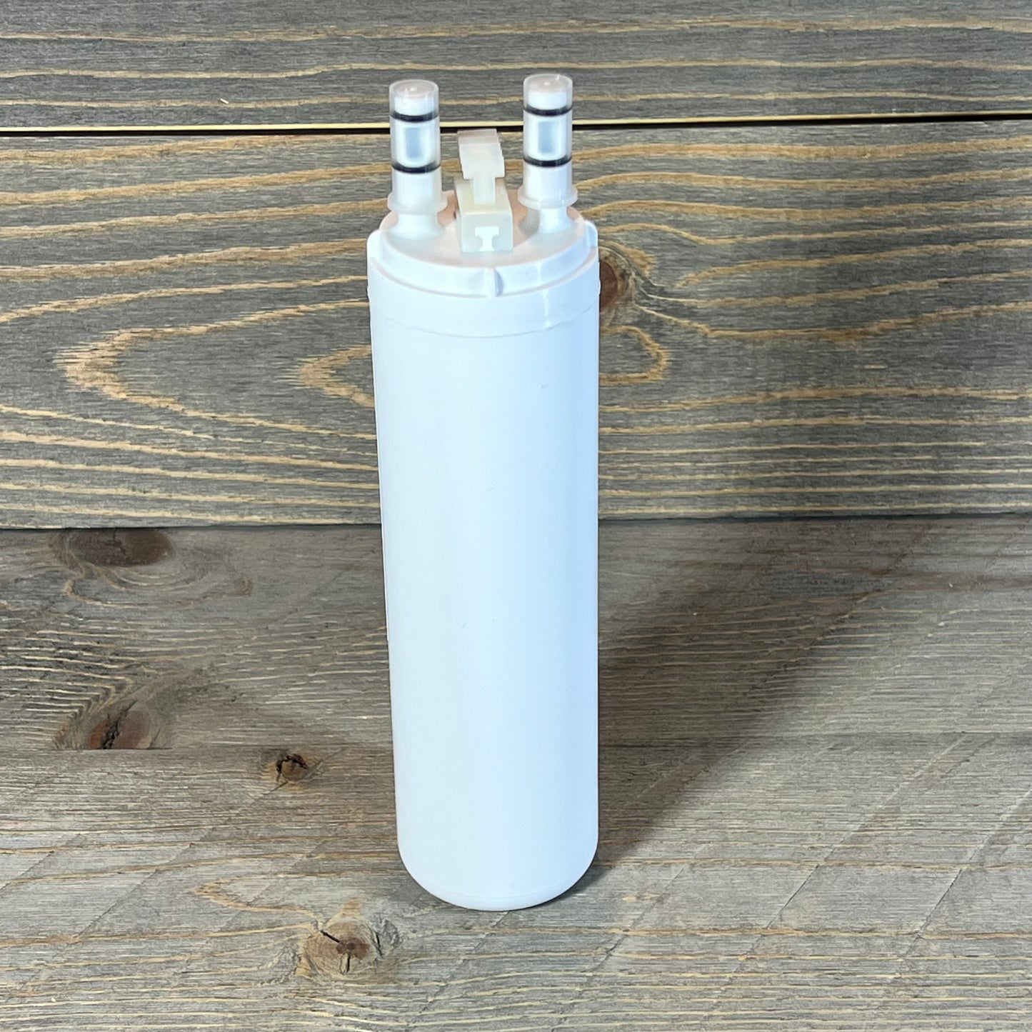 Tall, cylindrical Frigidaire WF3CB PureSource3 filter cartridge on a rustic wooden surface.