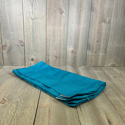 Teal blue waterproof pillow covers on wooden background, ideal for outdoor patio decor and garden cushions, 18x18 inches.