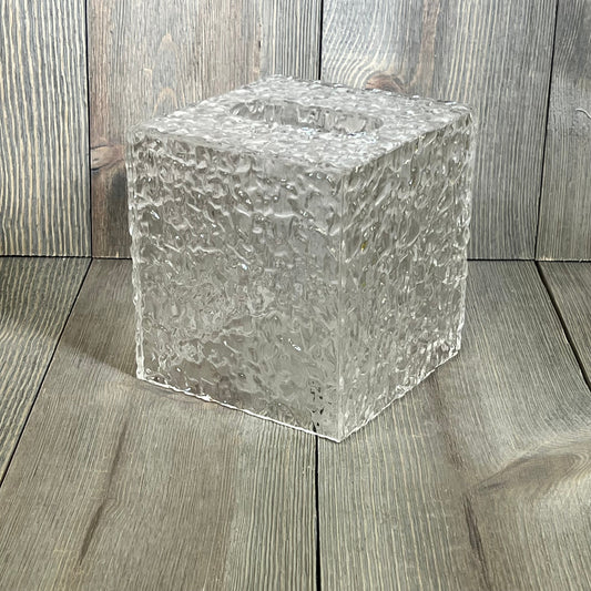 Clear acrylic tissue holder with ripple texture, showcasing modern design on wooden surface, perfect for bathroom decor.
