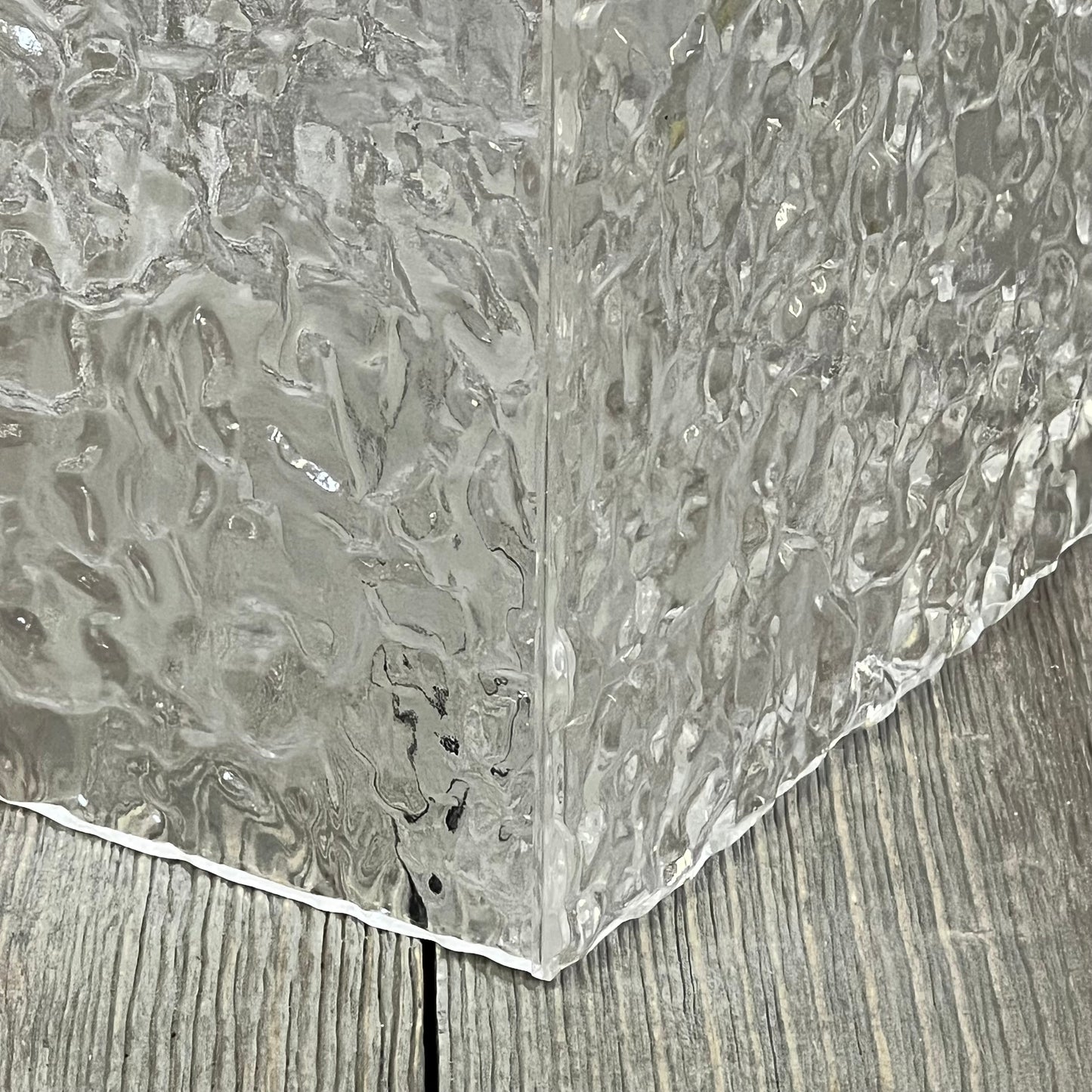 Clear acrylic tissue holder with modern ripple texture, showcasing a stylish transparent design for bathroom decor.