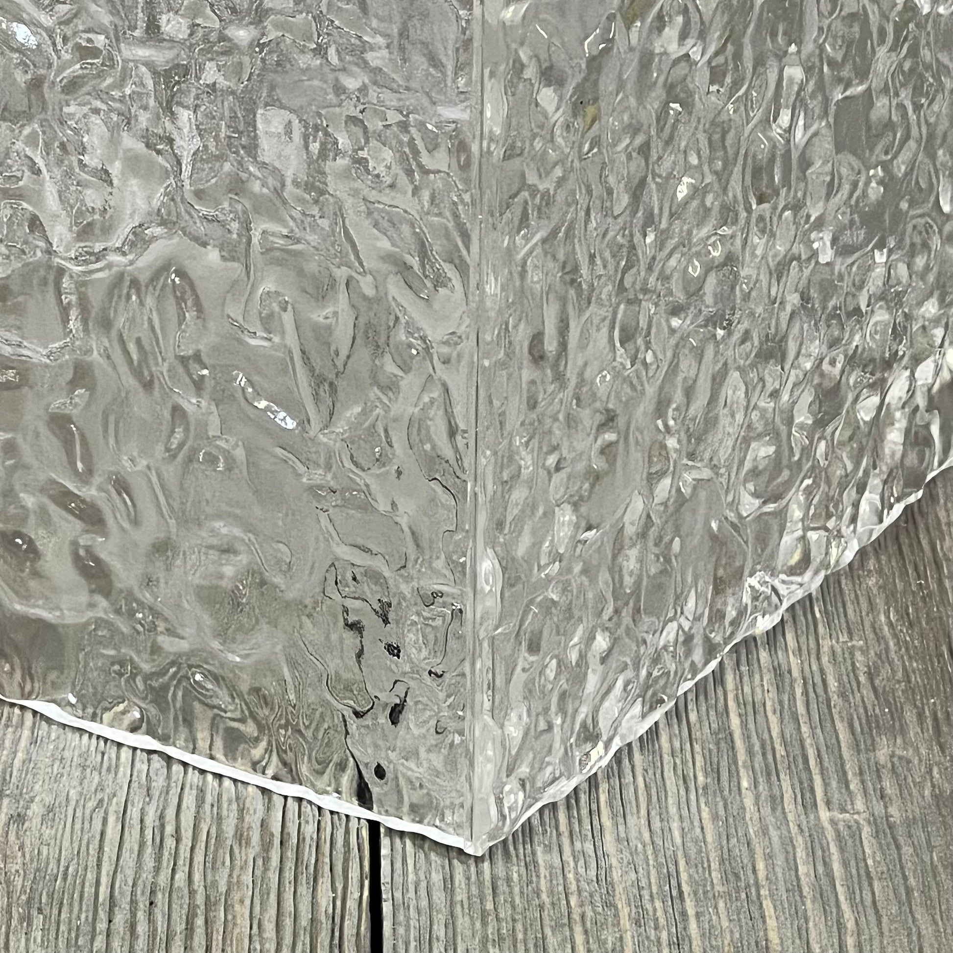 Clear acrylic tissue holder with modern ripple texture, showcasing a stylish transparent design for bathroom decor.