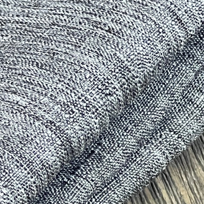 Textured grey linen tablecloth close-up, showing waterproof and wrinkle-free fabric ideal for dining and events.