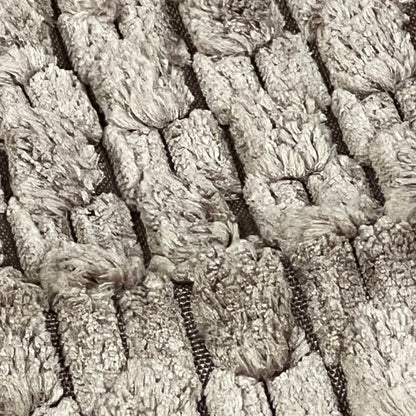 Textured close-up of light brown corduroy fabric on Kevin Textile throw pillow cover, showcasing rustic boho design.