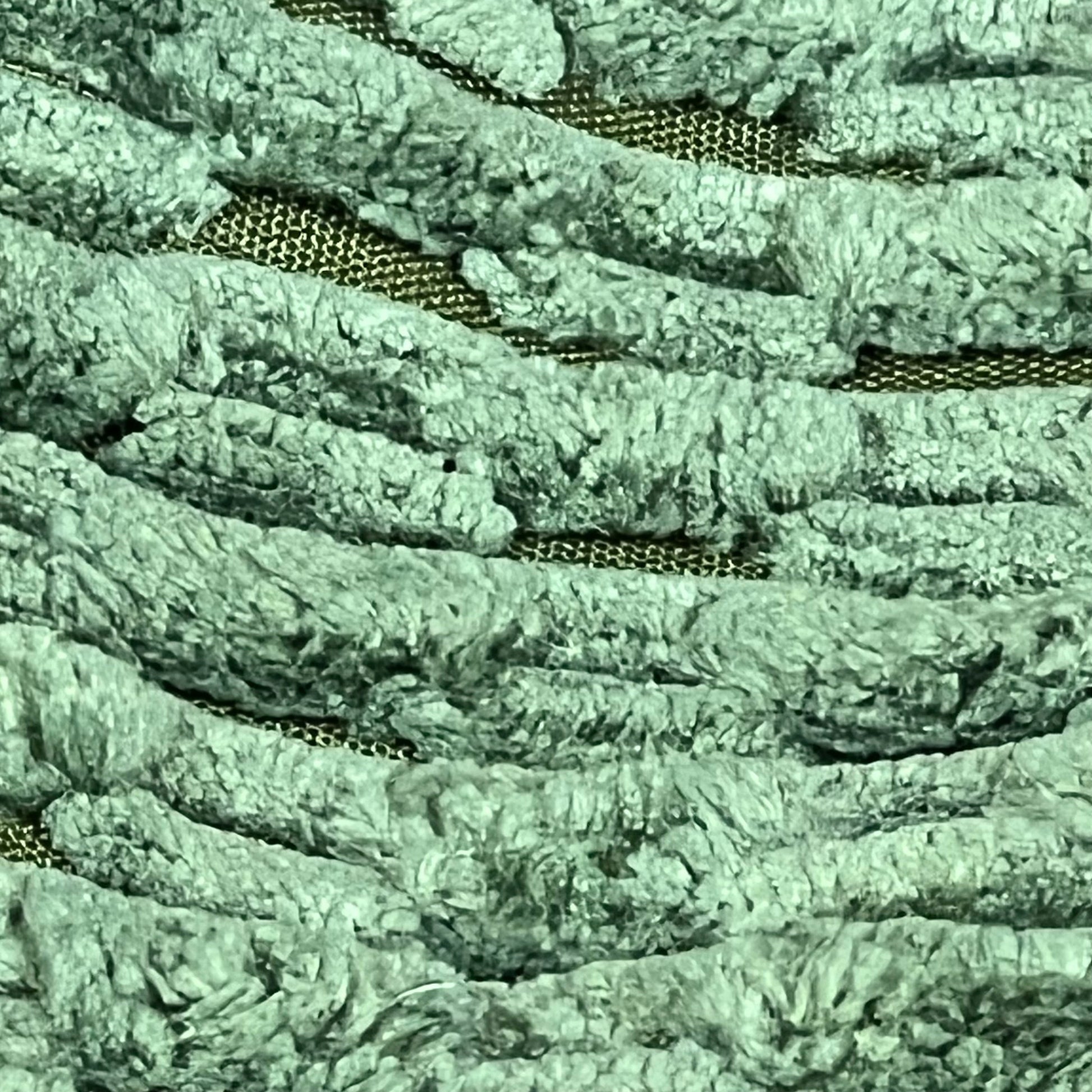 Close-up of moss green corduroy texture on Kevin Textile throw pillow cover, featuring boho stripes for home decor.
