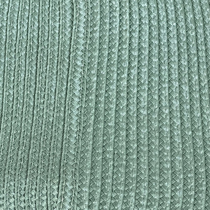Sage green woven vinyl placemat with textured design, non-slip and heat-resistant for dining table, easy to clean.