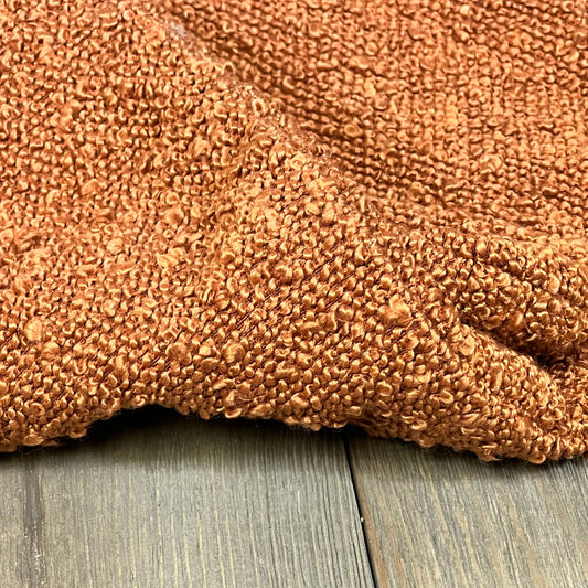 Rust-colored boucle textured throw pillow cover, 18x18 inch, perfect for modern home decor on couch or bed.