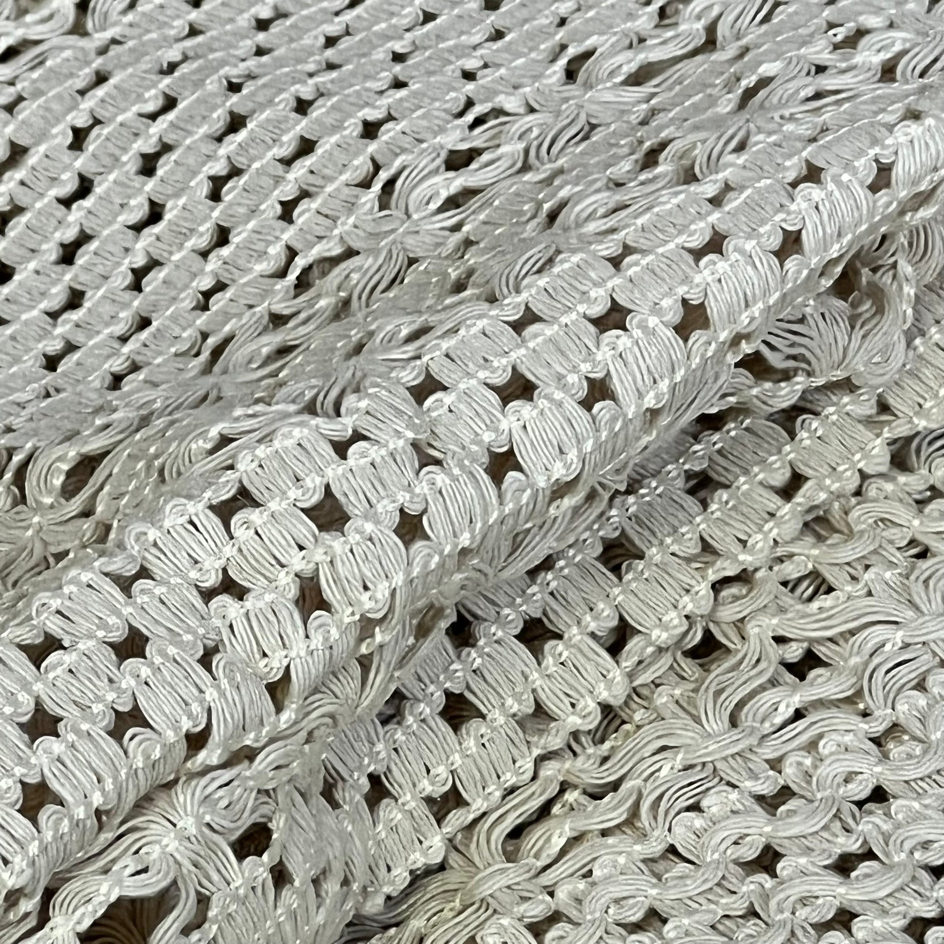 Cream beige macrame table mat close-up, showcasing intricate cotton linen weave and tassel details for farmhouse decor.