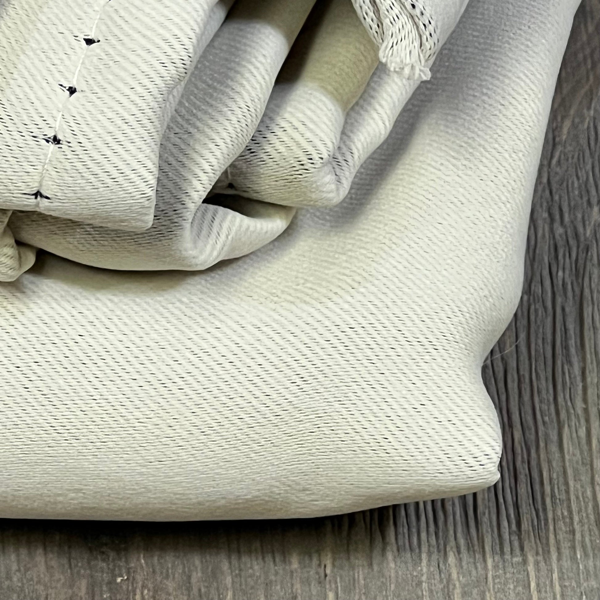 Beige NICETOWN kitchen curtains, thermal insulated for room darkening, folded on wooden surface, size W42 x L63 inches.