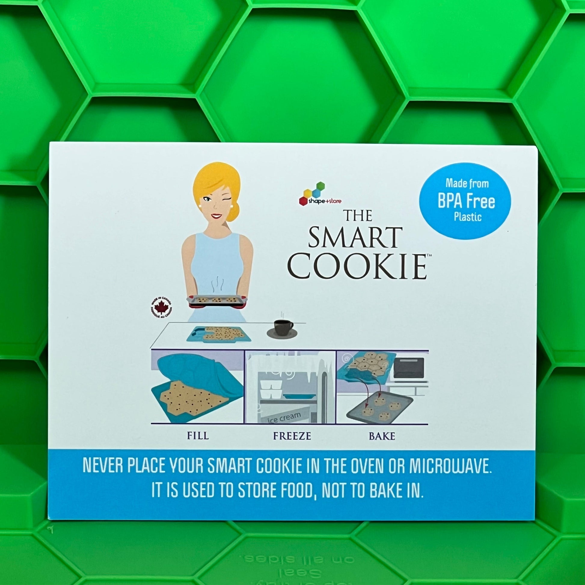 Smart Cookie Tray packaging on a vibrant green hexagonal background, highlighting BPA-free and food storage features.
