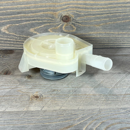 Top load washer drain pump and pulley replacement on a rustic wooden surface, showcasing detailed design and functionality.