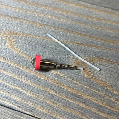 Tungsten carbide nozzle 0.4mm for E3D Revo HotEnd on wooden surface, showcasing high thermal conductivity.