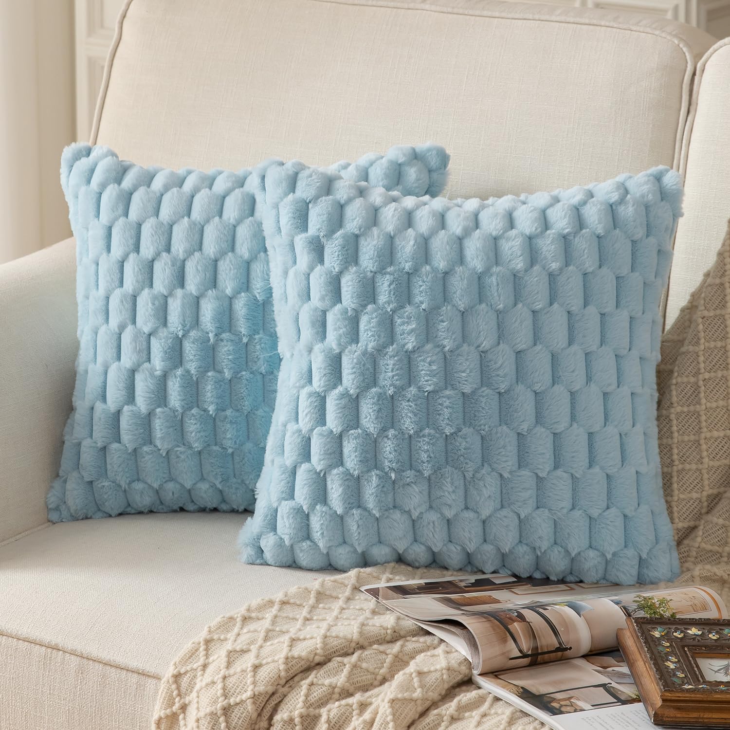 Light blue plush throw pillow covers on a sofa, showcasing a fluffy faux fur texture for living room decor.